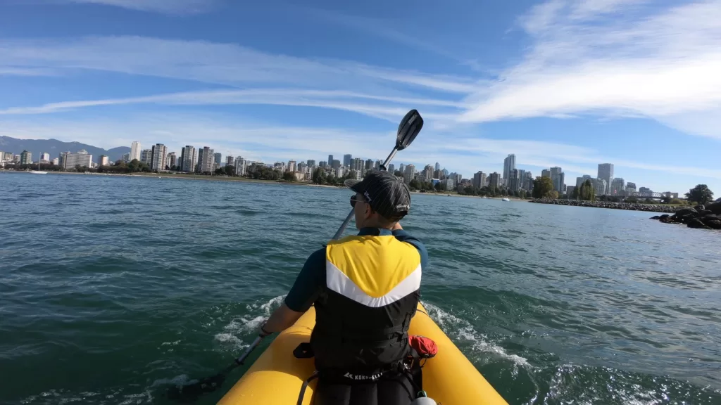 Chin paddling towards English Bay on his Kokopelli Packraft